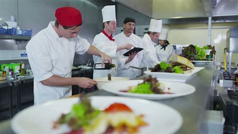 Kitchen staff plating dishes during service